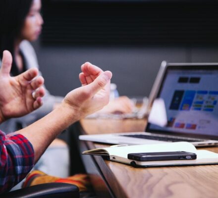 A team in an office discussing requests for proposals during a meeting